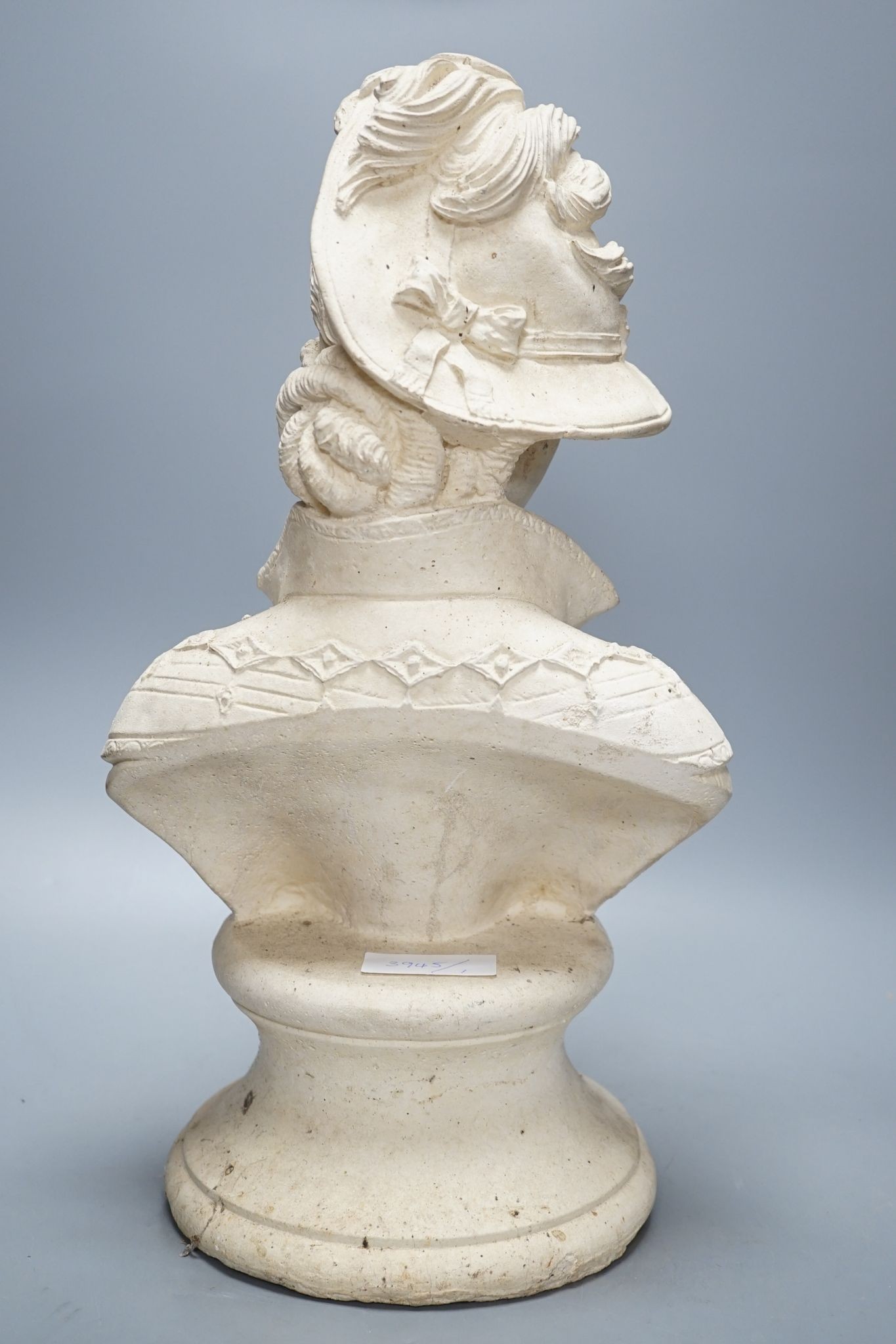 A composition bust of a 19th century lady in feather hat, 47 cms high.